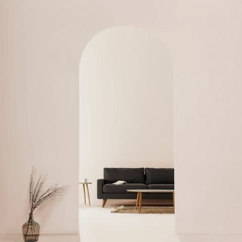 Bright white room with a plaster arch, standing in for a polished Calacatta Oro slab
