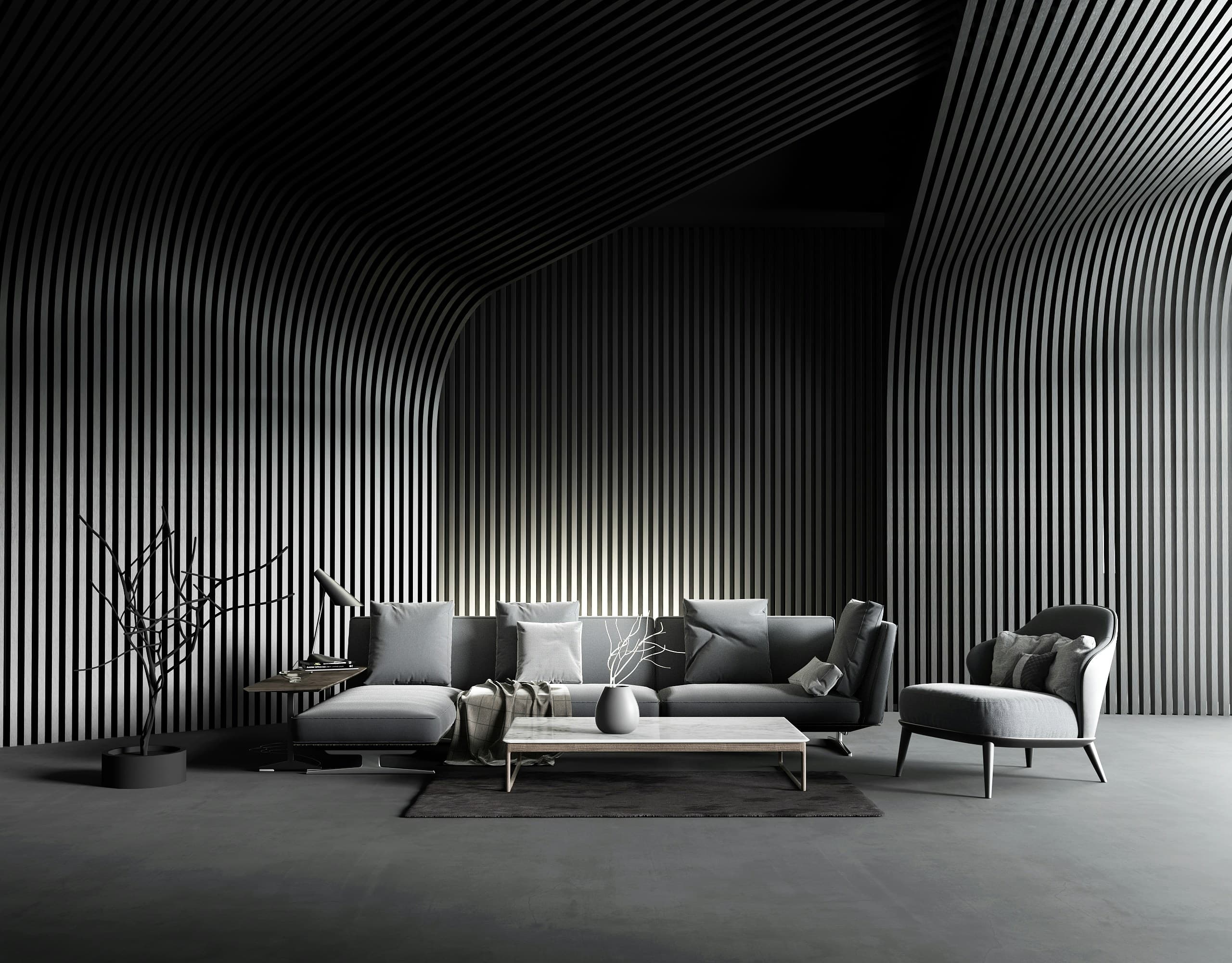 A contemporary showroom living area with warm stone finishes, a sculptural lamp and layered natural textures.