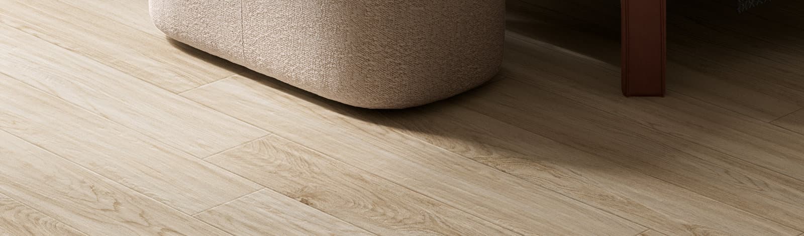 A softly lit bedroom corner, a rounded plaster bedside form standing on wide oak boards