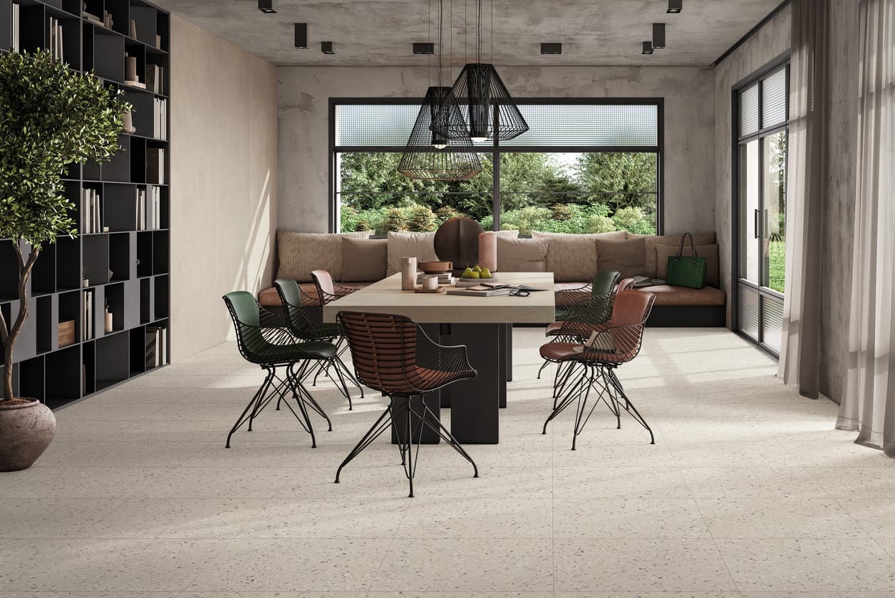 Concrete-effect kitchen with a long timber table under black-framed glazing