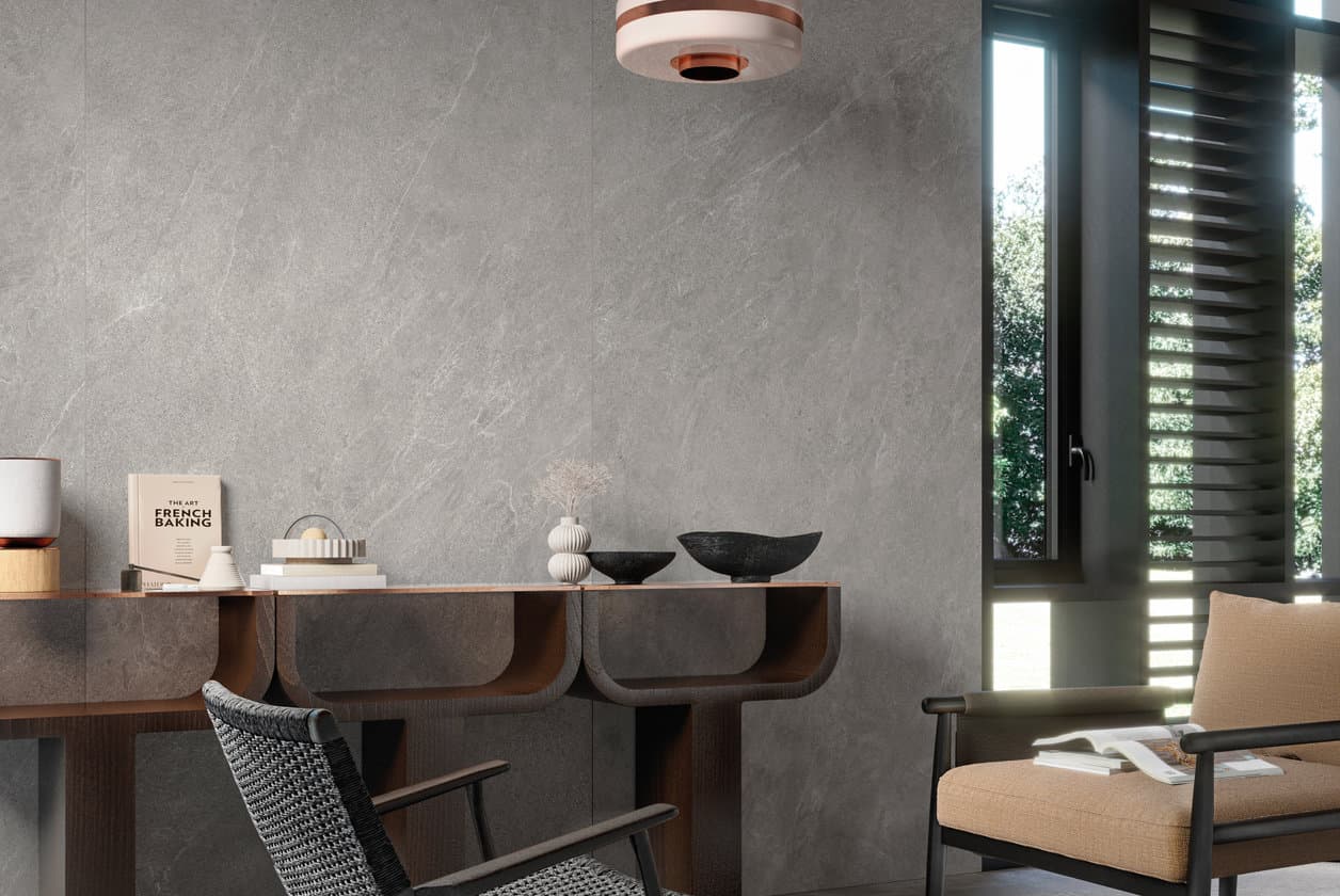 Stone-effect living room with a curved sofa and a pale lounge chair