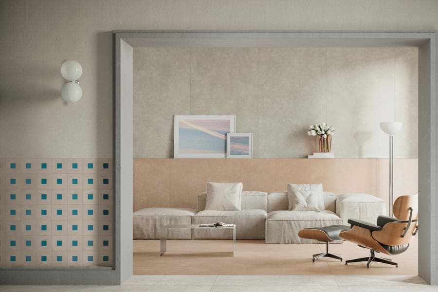 Terrazzo-clad bedroom with a lounge chair and framed artwork
