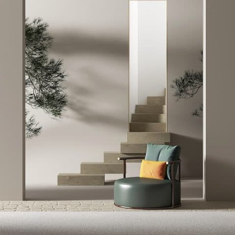 Deep green upholstered lounge chair beside a travertine stair, under an olive-tree shadow